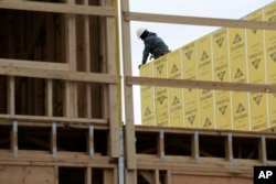 FILE- Work continues on a new development in Fair Lawn, N.J., Feb. 26, 2018. On Friday, the Labor Department will release its report on how many jobs U.S. employers added in March.