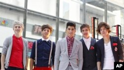 Members of British-Irish band One Direction pose after performing on NBC's "Today" show in New York March 12, 2012.