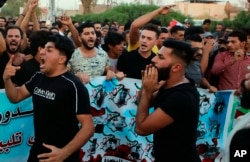Protesters chant slogans during a demonstration demanding better public services and jobs in Basra, Iraq, Sept. 28, 2018.
