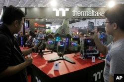 Visitors review Thermaltake's MFC 2 2nd Place MOD during the Computex Taipei, one of the world's largest IT expos, in Taipei, Taiwan, June 5, 2018.