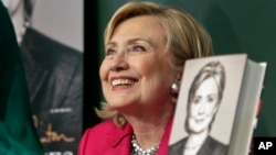 HiIlary Rodham Clinton listens before signing a copy of her book, "Hard Choices" at Barnes and Noble bookstore in New York, June 10, 2014.