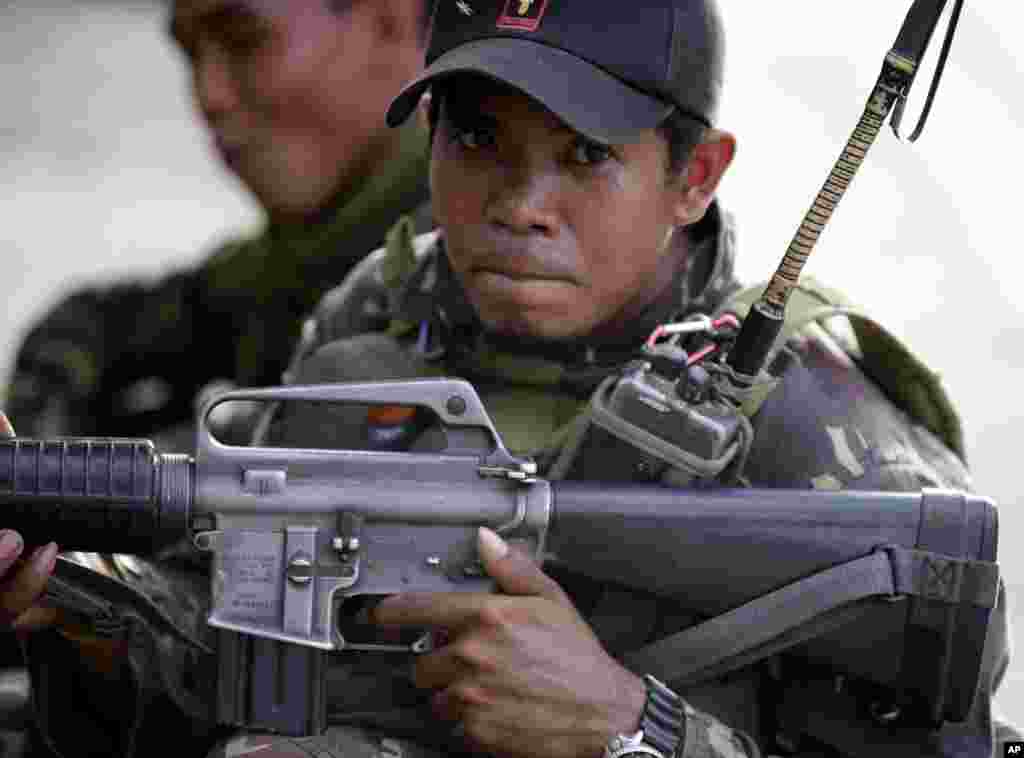 A government trooper takes his position during a standoff in the southern port city of Zamboanga, Philippines, Sept. 10, 2013.