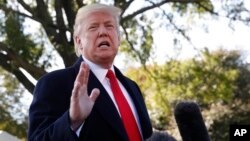 President Donald Trump stops to talk to the media before walking across the South Lawn of the White House in Washington, Oct. 22, 2018.