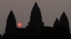 In this Friday, March 20, 2015, file photo, the sun rises behind Angkor Wat at the eastern site of Siem Reap province, some 230 kilometers (143 miles) northwest of Phnom Penh, Cambodia. Visitors who dress immodestly will not be allowed to enter Cambodia's