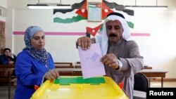 A Jordanian man casts his ballot at a polling station for parliamentary elections in Amman, Sept. 20, 2016
