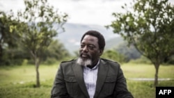 FILE - President of the Democratic Republic of the Congo, Joseph Kabila, sits in a garden at his personal ranch in Kinshasa, Dec. 10, 2018.