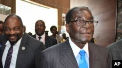 FILE: Zimbabwe's President Robert Mugabe, right, arrives for the heads of state meeting of the annual African Union (AU) summit, held at the AU headquarters in Addis Ababa, Ethiopia, Jan. 30, 2015.