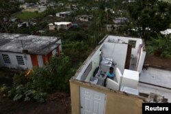 Ernestina Lebron looks at her refrigerator in her home in Maunabo, Jan. 27, 2018.