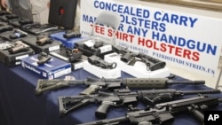 Guns are displayed during a rally at the state Capitol in Oklahoma City, Oklahama, May 8, 2012.