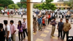 Cambodians wait on a line before they vote at a polling station in Phnom Penh, file photo. 