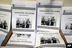 In this Wednesday, March 25, 2019, photo are learning guides to be distributed to students at John H. Webster Elementary School in Philadelphia. Only about half of the district’s high school students have a laptop or tablet and home internet service. (AP)