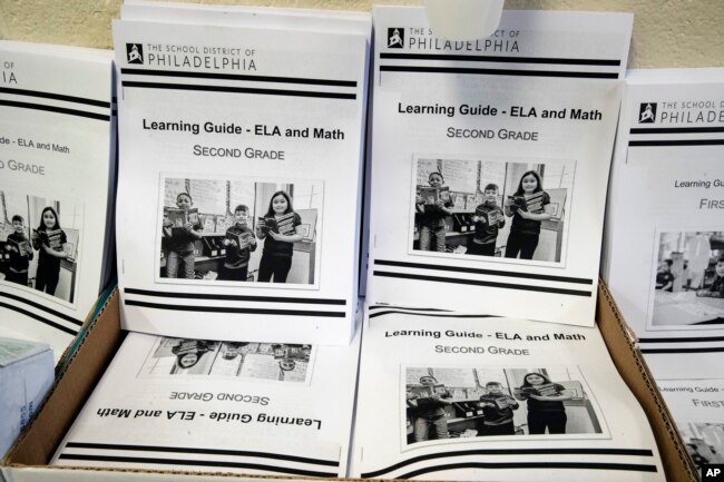In this Wednesday, March 25, 2019, photo are learning guides to be distributed to students at John H. Webster Elementary School in Philadelphia. Only about half of the district’s high school students have a laptop or tablet and home internet service. (AP)
