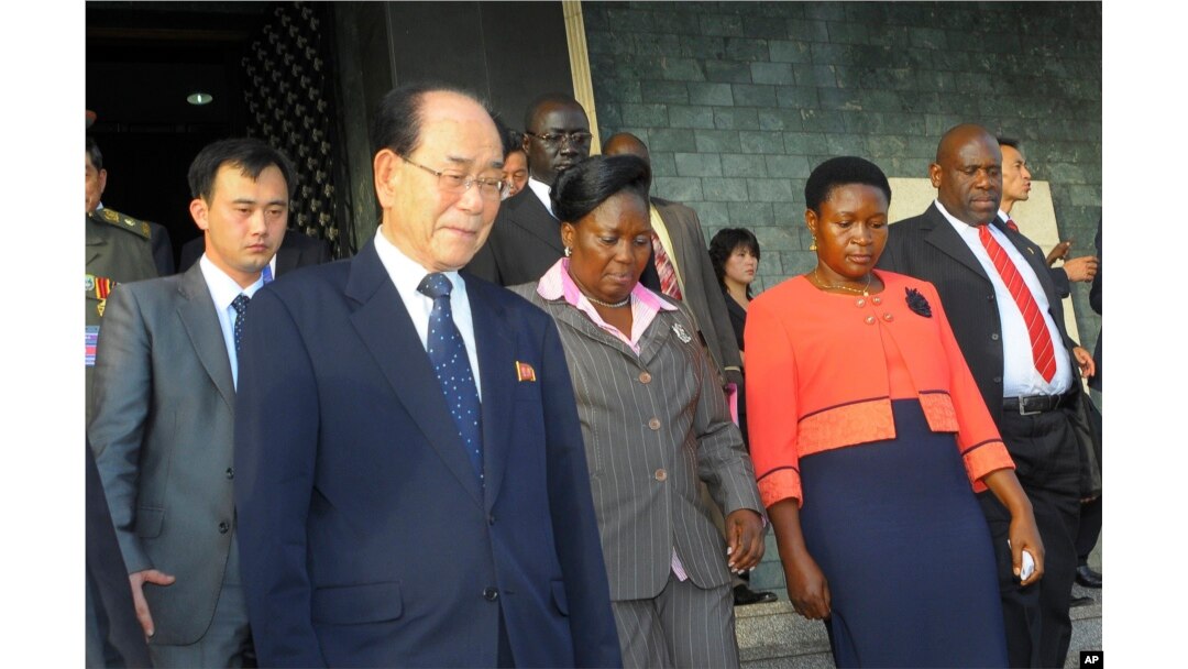 FILE - North Korea’s ceremonial leader, Kim Yong Nam, foreground,left, the head of North Korea’s parliament, is escorted into Uganda's parliament by its Speaker Rebecca Kadaga, center, Commissioner Rosemary Seninde, center-right, and Uganda's Foreign Affairs Minister Asuman Kiyingi, right, in Kampala, Uganda, Oct. 30,2014.