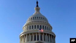 A flag flies on at the U.S. Capitol in Washington, Nov. 28, 2017. The House was set to vote Nov. 29 on adopting mandatory anti-sexual harassment training for all members and their staffs.