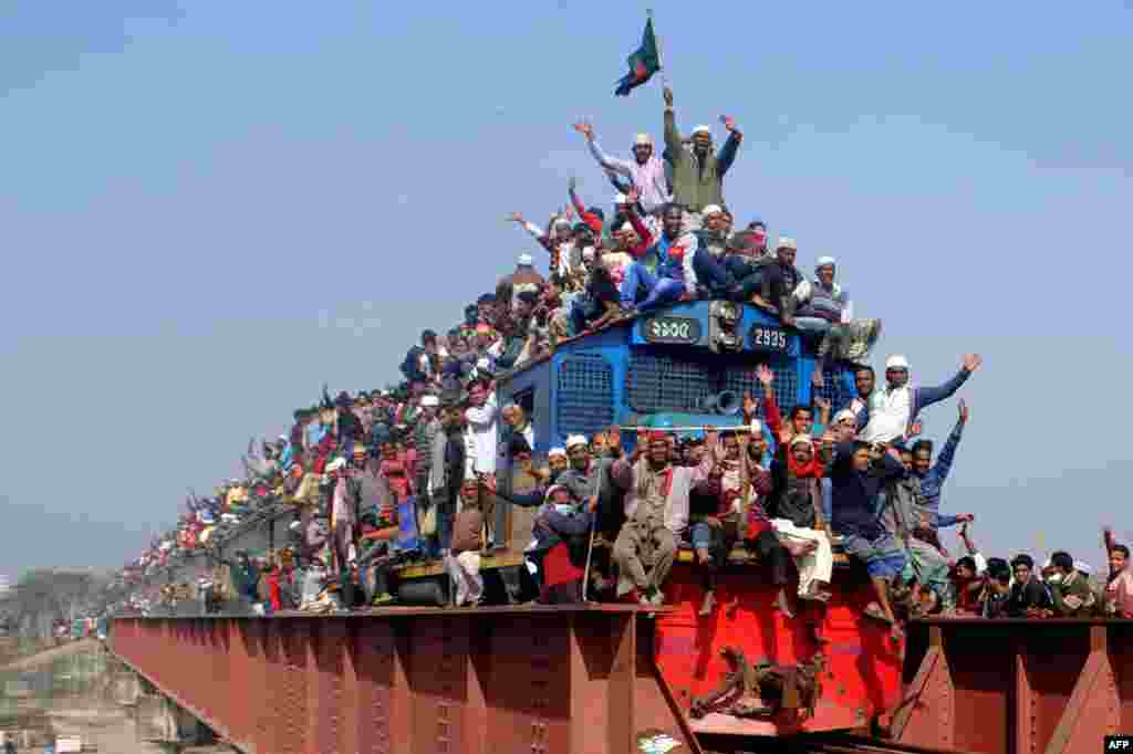 Muslim participants gesture from a departing train following the conclusion of the World Muslim Congregation, also known as Biswa Ijtema, at Tongi, on the outskirts of the Bangladesh capital Dhaka.