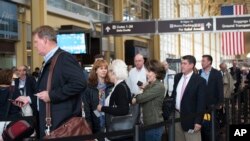 Passengers wait in a security line at Washington's Ronald Reagan National Airport in Washington, May 13, 2016. Fliers across the country have been facing growing lines.