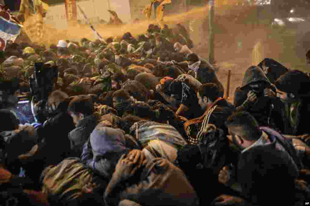 Turkish riot police clash with demonstrators who were protesting against Turkey's policy in Syria, in Istanbul, Turkey, Oct. 7, 2014.