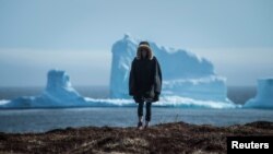 A resident views the first iceberg of the season as it passes the South Shore, also known as "Iceberg Alley", near Ferryland Newfoundland, Canada April 16, 2017.