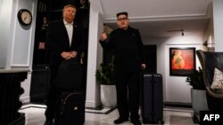 North Korean leader Kim Jong Un impersonator Howard X (R) and U.S. President Donald Trump impersonator Russel White walk at the lobby of a hotel before being escorted by Vietnamese authorities to the airport, in Hanoi, Feb. 25, 2019. 