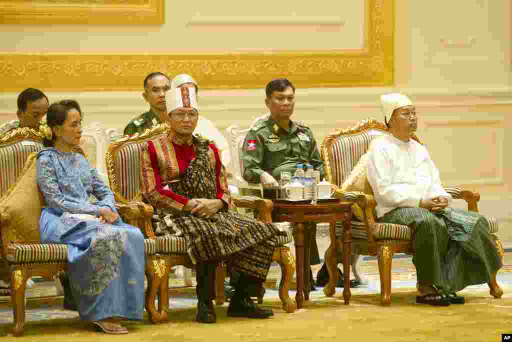 Aung San Suu Kyi, left, vice president Henry Van Thio and Myint Swe, right, attend the handover ceremony at the presidential palace in Naypyidaw.
