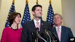 Rep. Paul Ryan, R-Wis., flanked by Rep. Cathy McMorris Rodgers, R-Wash., left, and House Majority Leader Kevin McCarthy of Calif., pauses during a news conference on Capitol Hill in Washington, Oct. 28, 2015, after a Special GOP Leadership Election. Republicans in the House of Representatives have nominated Ryan to become the chamber's next speaker.