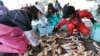 FILE - Japanese women sort through freshly caught fish at the Hirakata fish market in Kitaibaraki, Ibaraki prefecture, south of the stricken Fukushima Daiichi nuclear power plant No. 1, April 6, 2011.