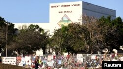 A memorial seen outside of Marjory Stoneman Douglas High School as students arrive for the first time since the mass shooting in Parkland, Florida, Feb. 28, 2018.