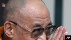 Tibet's exiled spiritual leader, the Dalai Lama, gestures to members of the public during his visit to St Brigid's Church in Kildare, Ireland April 13, 2011