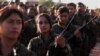 FILE - Fighters from the Syrian Democratic Forces attend the funeral a fellow fighter killed in the town of Hajin during battles against the Islamic State group, in the Kurdish-controlled city of Qamishly in northeastern Syria, Dec. 3, 2018. 