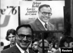 FILE - Helmut Kohl stands in front of an election poster, June 26, 1975, during an election campaign for the West German 1976 general election.