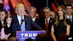 Republican presidential candidate Donald Trump speaks during a primary night news conference, Tuesday, April 26, 2016, in New York, as Melania Trump listens at right. (AP Photo/Julie Jacobson)