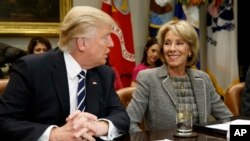 President Donald Trump looks at Education Secretary Betsy DeVos as he speaks during a meeting with parents and teachers in the Roosevelt Room of the White House in February. (AP Photo/Evan Vucci)