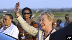U.S. Secretary of State Hillary Clinton waves on arrival at Julius Nyerere International Airport in Dar es Salaam, Tanzania, June 11, 2011.