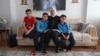 Fatima Alzahra Shon, 32, a Syrian refugee, poses with her children in their apartment in Istanbul, Turkey, Sept. 17, 2021. 