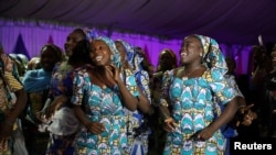 Some of the 106 girls who were kidnapped by Boko Haram militants in the Nigerian town of Chibok, are seen dancing joyfully during the the send-forth dinner organised for them in Abuja, Nigeria, Sept. 13, 2017.