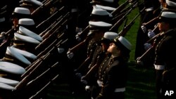 A midshipman lifts her face to the sun at the end of a formal dress parade by the Brigade of Midshipmen at the U.S. Naval Academy in Annapolis, Md. on Wednesday, April 7, 2010. (AP Photo/Jacquelyn Martin)