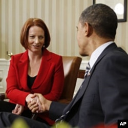 U.S. President Barack Obama (R) shakes hands with Australia's Prime Minister Julia Gillard in the Oval Office of the White House, March 7, 2011