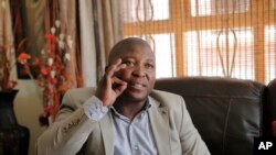 Thamsanqa Jantjie gestures at his home during an interview with AP in Johannesburg, Dec. 12, 2013.