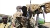 Militiamen from the Ansar Dine Islamic group sit on a vehicle in Gao in northeastern Mali, June 18, 2012. 