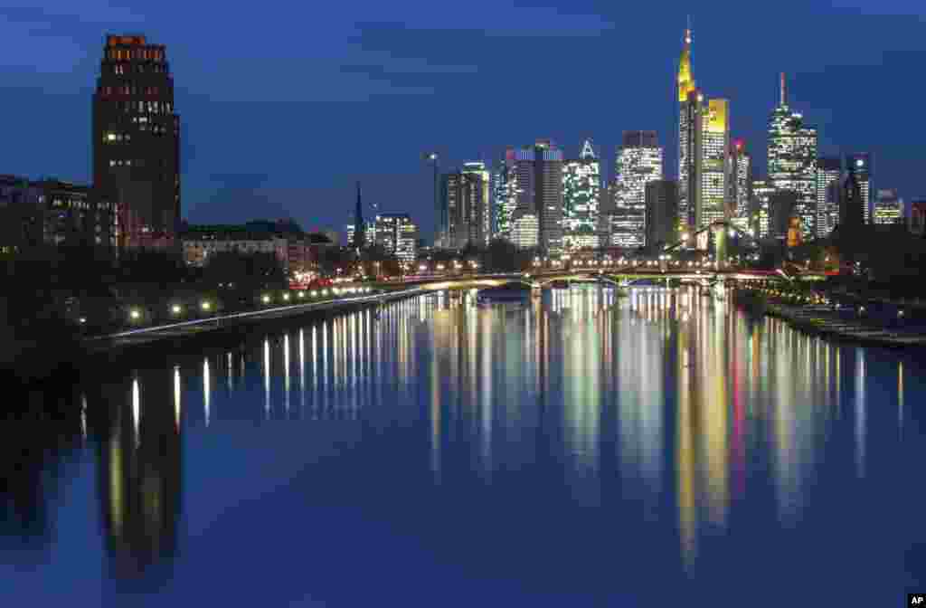 The banking towers of the Frankfurt skyline are mirrored in the Main river in Frankfurt, Germany, Nov. 1, 2017.