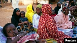 FILE - Displaced people are seen gathered at a house in Bamako February 21, 2014.