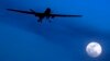 FILE - An unmanned U.S. Predator drone flies over Kandahar Air Field, southern Afghanistan, on a moon-lit night, Jan. 31, 2010.