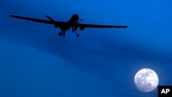 FILE - An unmanned U.S. Predator drone flies on a moonlit night, Jan. 31, 2010.
