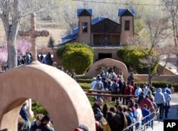 Thousands of Catholics traveled by foot to a small adobe church in Chimayo, New Mexico, March 30, 2018. The annual act of prayer, reflection and sacrifice attracts more than 20,000 people. Many set out before dawn and walk more than 30 miles (48 kilometers) along highways from Santa Fe and beyond.