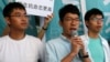 Newly elected lawmaker Nathan Law (C), student leaders Joshua Wong (R) and Alex Chow meet journalists outside a court before a hearing as prosecutors asked them to be jailed immediately over their roles in storming government headquarters in 2014 which led to Occupy Central pro-democracy movement, in Hong Kong, China September 21, 2016.