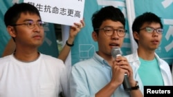 Newly elected lawmaker Nathan Law (C), student leaders Joshua Wong (R) and Alex Chow meet journalists outside a court before a hearing as prosecutors asked them to be jailed immediately over their roles in storming government headquarters in 2014 which led to Occupy Central pro-democracy movement, in Hong Kong, China September 21, 2016.