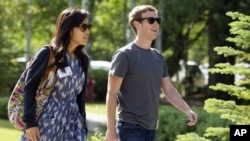 Mark Zuckerberg, president and CEO of Facebook, with his girlfriend Priscilla Chan during the 2011 Allen and Co. Sun Valley Conference, July 9, 2011, in Sun Valley, Idaho