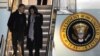 President Barack Obama and first lady Michelle Obama walk off Air Force One after arriving at O'Hare International Airport in Chicago, November 6, 2012. 