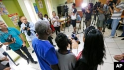 FILE - Members of a Haitian family living in the United States with Temporary Protected Status speak to reporters on May 22, 2017, in Miami, Florida.