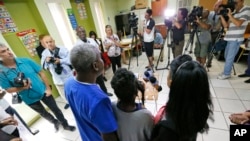 FILE - A Haitian family that did not want to be identified, living in the U.S. with Temporary Protected Status (TPS), speaks to members of the media in Miami, May 22, 2017. 